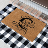 clay/monogram doormat