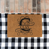 clay/monogram doormat
