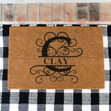clay/monogram doormat