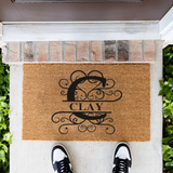 clay/monogram doormat